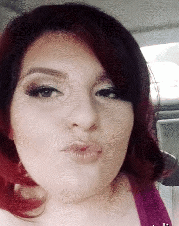 a close up of a woman 's face with a kiss on her lips