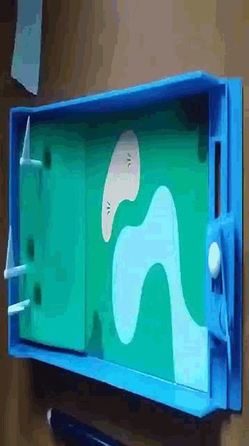a blue and green toy with a golf course design