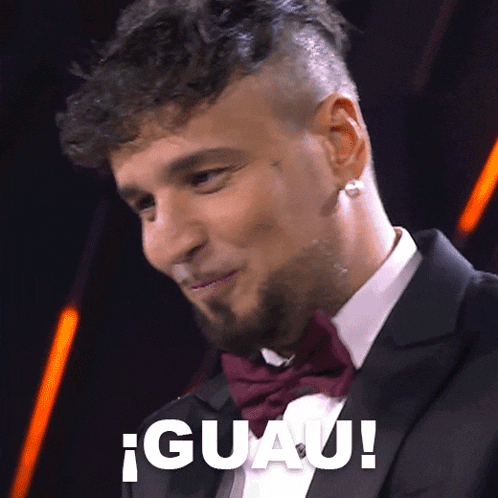 a man in a tuxedo and bow tie says " guap "