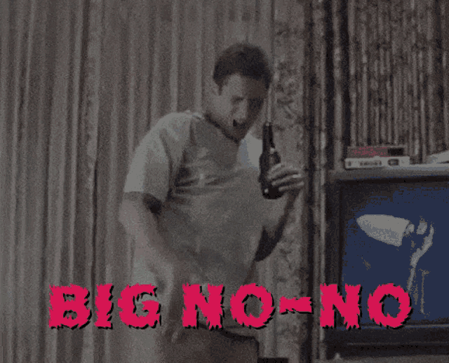 a man in a green shirt is holding a bottle of beer in front of a tv screen that says big no no
