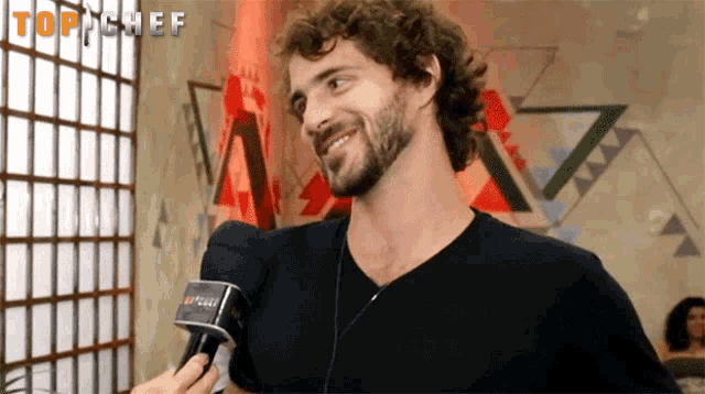 a man with a beard is being interviewed by a top chef