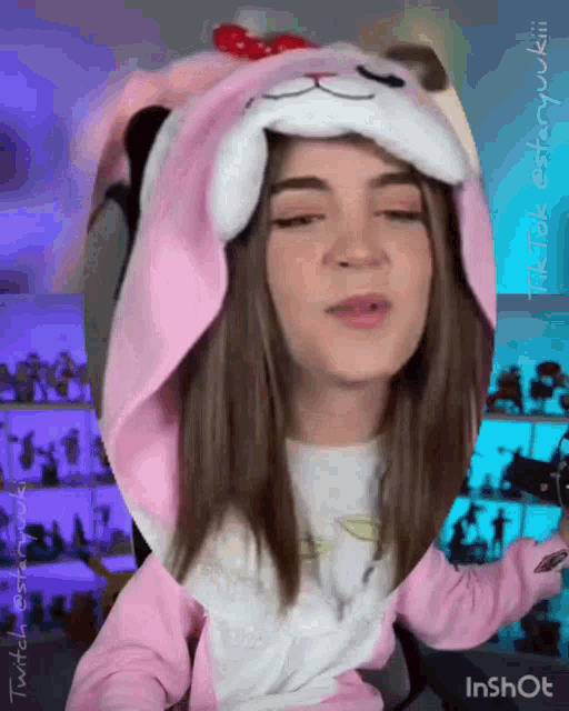 a girl wearing a hello kitty costume is making a face