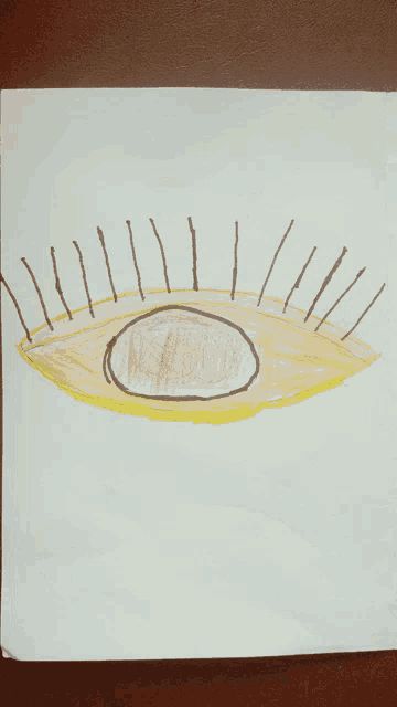 a child 's drawing of an eye with a circle in the center