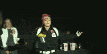 a woman with red hair is wearing a black jacket with the number 21 on the back