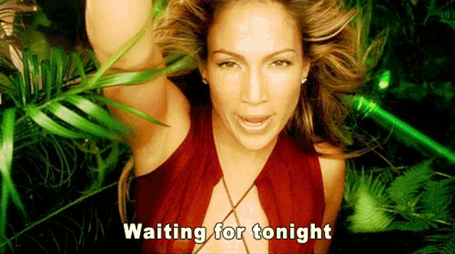 a woman in a red dress is surrounded by green plants and says waiting for tonight
