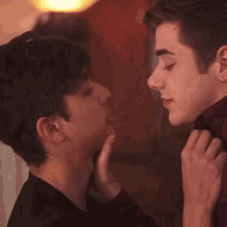 a man and a woman are kissing each other in a room .