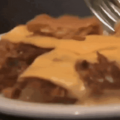 a close up of a plate of food with a fork in it