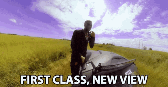 a man standing in a field with the words " first class new view " above him