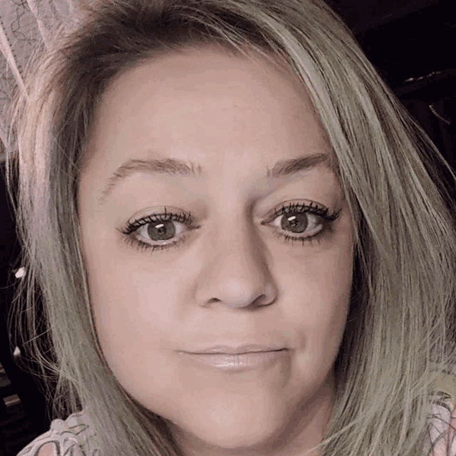 a close up of a woman 's face with makeup on