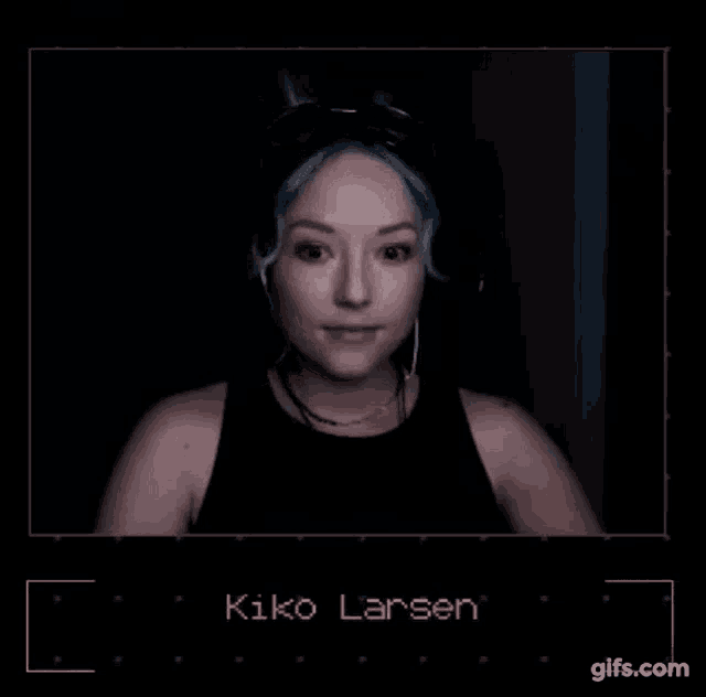 a woman with blue hair is wearing headphones and the name kiko larsen is on the screen