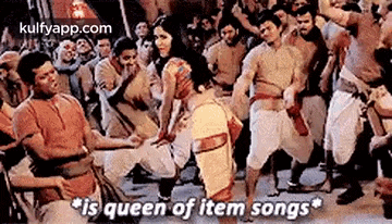 a group of people are dancing in a crowd and a man is kneeling down in front of a crowd .