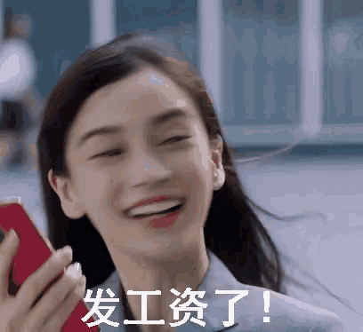 a woman in a suit is smiling and holding a cell phone in her hand