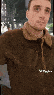 a man wearing a brown jacket with a viggle.ai logo on the front