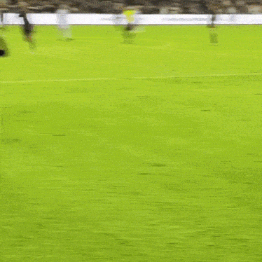 a soccer player with the number 23 on his shirt is kneeling on the field