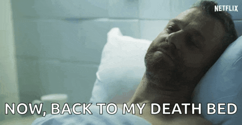 a man is laying in a hospital bed with the words " now back to my death bed " above him .