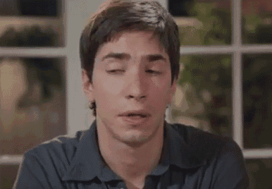 a close up of a man making a funny face with his eyes closed .