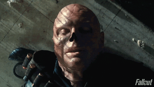 a man laying on the ground with fallout written on the bottom of the image
