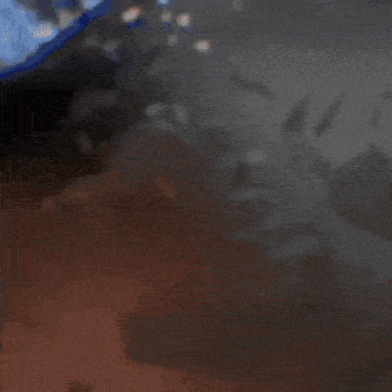 a close up of a person 's face with a blurred background of a dark room