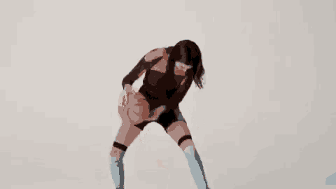 a woman is holding a basketball in her hands while kneeling down .