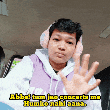 a man wearing headphones and a purple hoodie says abbe tum jao concerts me humko nahi ana