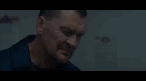 a close up of a man 's face in a dark room .