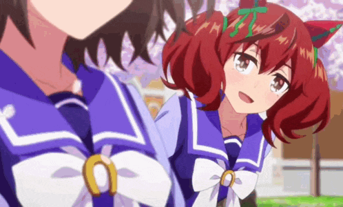 a couple of anime girls are standing next to each other in a park .