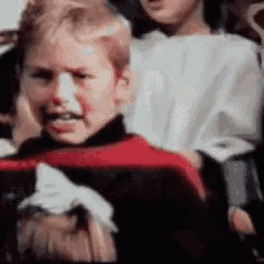 a group of children are singing in a choir .