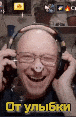 a man wearing headphones with a pig nose on his face laughs