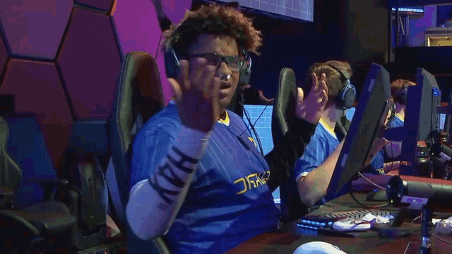 a man wearing headphones and a shirt that says v-h-u