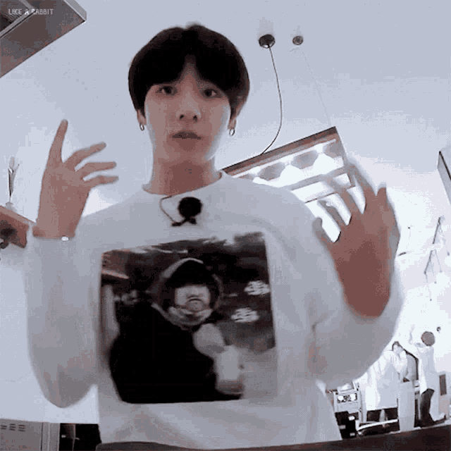 a man wearing a white shirt with a picture of a man on it