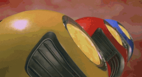 a yellow object with a red and blue object in the background