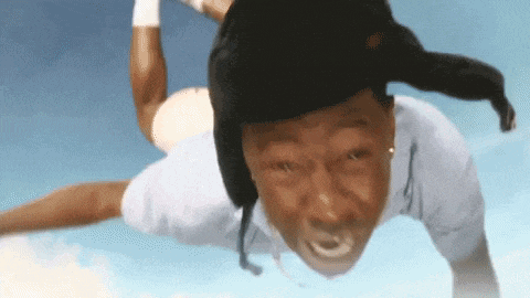 a man wearing a hat is flying in the air