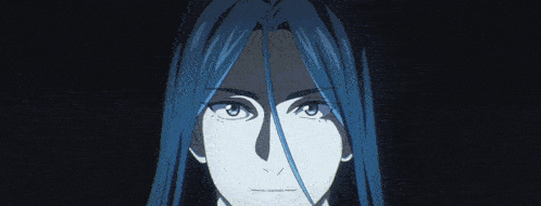 a man with long hair holds a blue ball in his hands