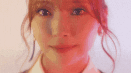 a close up of a woman 's face with a red background .