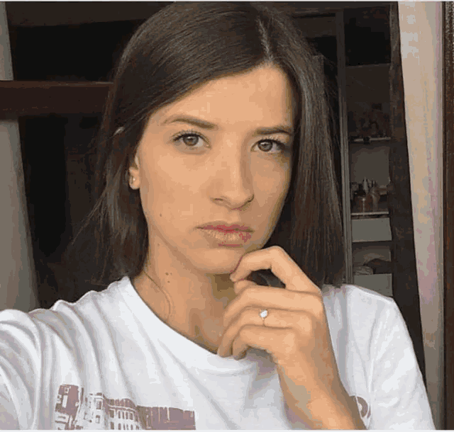 a woman wearing a t-shirt that says ' italy ' on it takes a selfie