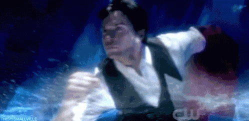 a man in a tuxedo is swimming in a pool .