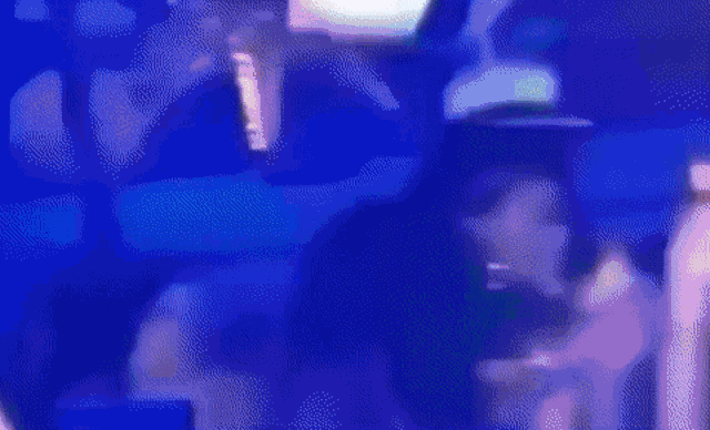 a blurry picture of a person dancing in a club with money falling from the ceiling