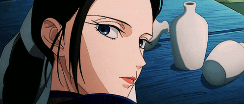 a close up of a woman 's face with a vase in the foreground