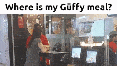 a woman is standing in front of a mcdonald 's ordering a meal .