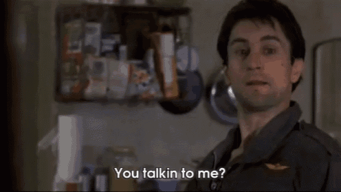 a man in a military uniform is talking to another man in a kitchen ..