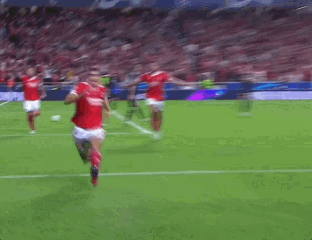 a group of soccer players are running on a field and one of them is wearing a jersey that says ' united '
