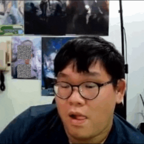 a man wearing glasses is making a funny face