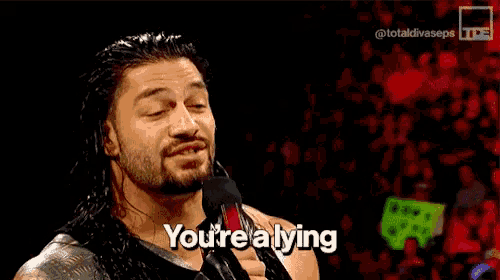 a man talking into a microphone with the words you 're a lying below him