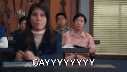 a group of people are sitting in a classroom with a woman sitting in front of them .