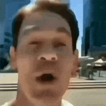 a blurry picture of a man with his mouth open
