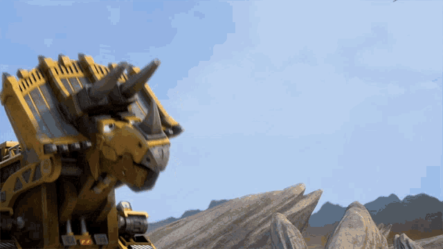 a yellow robot with horns is standing in a desert