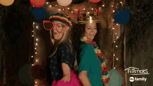 two women are posing for a picture in a photo booth with the foster 's abc family logo on the bottom