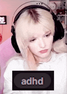 a girl wearing headphones has the word adhd on the screen