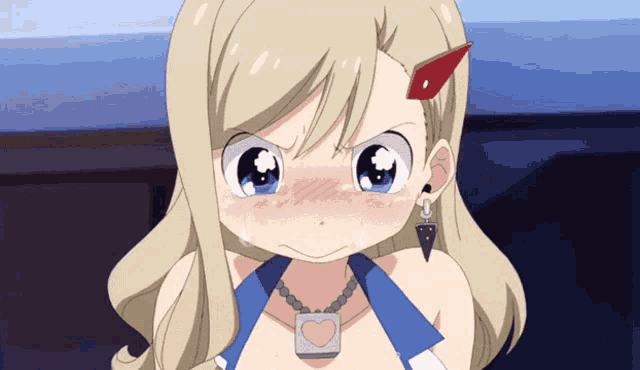 a girl with blonde hair and a heart necklace