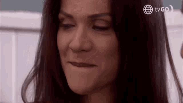 a woman is making a funny face with her eyes closed and her mouth open .